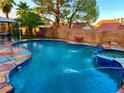 Inviting backyard pool and spa with stone decking, perfect for relaxation and outdoor entertaining at 7400 Amigo St, Las Vegas, NV 89123