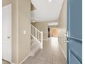 Inviting entryway featuring tiled floors, staircase, and a view into the living spaces at 7931 Mineral Peak St, Las Vegas, NV 89166