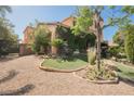 A charming home featuring decorative landscaping, a fountain, and a gated driveway at 7947 Lookout Rock Cir, Las Vegas, NV 89129