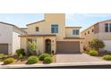 Charming home with an arched doorway, two-car garage, and well-manicured landscaping at 812 Stannard Ct, Henderson, NV 89052