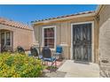 Inviting front porch with a seating area and decorative metal door at 821 Tollbrook Way, Henderson, NV 89011