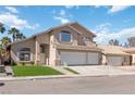 View of two-story home with a three-car garage and manicured lawn at 8714 Las Posas Ave, Las Vegas, NV 89147