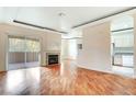 Bright living area featuring hardwood floors, fireplace, slider doors to balcony, and an adjacent kitchen at 8725 Red Rio Dr # 203, Las Vegas, NV 89128