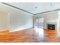 Open living room with hardwood floors, recessed lights, sliding glass door, and a granite fireplace at 8725 Red Rio Dr # 203, Las Vegas, NV 89128