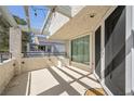 Private balcony with shaded pergola cover, string lights, neutral tones, and sliding glass door access at 8932 Antioch Way, Las Vegas, NV 89117