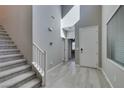 Inviting entryway with stairs, high ceilings, tile flooring, and access to the rest of the home at 9239 Albus Hills Ave, Las Vegas, NV 89143