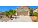 Charming two-story home featuring a tile roof and well-maintained landscaping with desert accents at 9408 Amber Valley Ln, Las Vegas, NV 89134