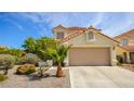 Beautiful single-Gathering home featuring desert landscaping, a two-car garage and a traditional roof at 9408 Amber Valley Ln, Las Vegas, NV 89134