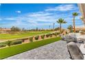 Expansive backyard with golf course views, manicured landscaping, and stylish patio furniture at 9513 Villa Ridge Dr, Las Vegas, NV 89134