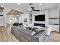 Open-concept living room with modern furnishings, fireplace, and wood-look flooring at 9513 Villa Ridge Dr, Las Vegas, NV 89134