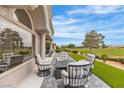 Covered patio featuring comfortable seating with golf course and lush landscaping views at 9513 Villa Ridge Dr, Las Vegas, NV 89134