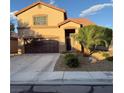 Inviting two-story home showcasing desert landscaping, a two-car garage, and a warm, welcoming facade at , North Las Vegas, NV 89031