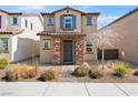 Charming two-story home showcasing stone accents, low maintenance landscaping, and a tiled roof at 1023 Brilliant Meadow Ave, North Las Vegas, NV 89086