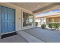 Inviting front porch with blue door and space for outdoor seating at 10791 Silver Lace Ln, Las Vegas, NV 89135