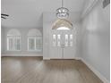 Bright living room featuring a high ceiling, arch window, and tiled floors at 11158 Antonine Wall Ct, Las Vegas, NV 89141