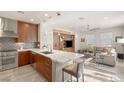 Modern kitchen featuring stainless steel appliances, a large island, and a seamless flow to living area at 11398 Belmont Lake Dr # 104, Las Vegas, NV 89135