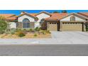 Charming single-story home with a well-maintained lawn, desert landscaping and a two-car garage at 1432 Castle Crest Dr, Las Vegas, NV 89117
