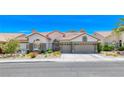 Beautiful single-story home with a three car garage, brick accents and lovely desert landscaping at 1432 Castle Crest Dr, Las Vegas, NV 89117