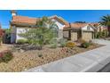 Charming single-story home featuring desert landscaping, a tile roof, and a stucco exterior at 1432 Castle Crest Dr, Las Vegas, NV 89117