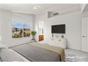 Light-filled bedroom featuring vaulted ceilings, plush carpet, and a view of the outdoors at 1540 Singing Bird Ln, North Las Vegas, NV 89031