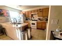 Well-lit kitchen featuring ample counter space, an island, and modern white appliances at 2131 Pillar Pointe St, Las Vegas, NV 89115