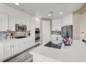 Bright and modern kitchen with stainless steel appliances, large island, and quartz countertops at 232 Delighted Ave, North Las Vegas, NV 89031