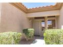 Covered entryway featuring a security door and well-maintained landscaping at 2501 Maddington Dr, Las Vegas, NV 89134