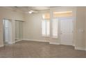 Bright living room with tile flooring, large mirror and a ceiling fan at 2501 Maddington Dr, Las Vegas, NV 89134