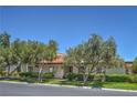 Well-kept single-story home with mature landscaping, a tile roof, and fresh green grass at 2531 La Cara Ave, Las Vegas, NV 89121
