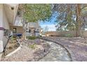 Backyard area features a stone pathway and rock landscaping for a peaceful outdoor retreat at 3396 Montessouri St, Las Vegas, NV 89117