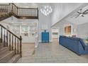 Bright and airy living room with a staircase, chandelier, and built-in shelving at 3396 Montessouri St, Las Vegas, NV 89117