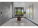 Bright foyer with modern decor, tiled floors, a decorative rug, and tall ceilings at 38 Skybird Ct, Las Vegas, NV 89135