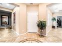Inviting foyer with decorative tile flooring, neutral paint, and a view into other rooms at 4015 Galiceno Dr, Las Vegas, NV 89122