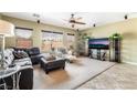 Cozy living area with comfortable seating, ceiling fan, and natural light from large windows at 4015 Galiceno Dr, Las Vegas, NV 89122
