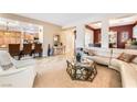 Open-concept living room featuring stylish furnishings and seamless flow to kitchen at 4015 Galiceno Dr, Las Vegas, NV 89122