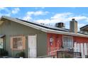 View of home exterior highlighting the roof-mounted solar panels and painted brick facade at 4565 Halbert Ave, Las Vegas, NV 89110