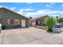 The exterior features a large drive, neutral colors, and an established landscape at 4565 Halbert Ave, Las Vegas, NV 89110