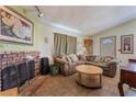 Inviting living room boasts brick fireplace and tiled floors at 4565 Halbert Ave, Las Vegas, NV 89110