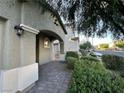Covered entrance with decorative pillars, arched doorway, and lush landscaping creating a welcoming ambiance at 4633 Fragrant St, North Las Vegas, NV 89031