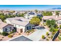 Overhead view of a home with solar panels on the roof nestled within a community of similarly styled homes in Nevada at 5017 Kaibab Forest Ave, Las Vegas, NV 89141