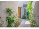 Exterior shot of a quaint stone walkway leading to the front entrance surrounded by lush, mature landscaping at 5017 Kaibab Forest Ave, Las Vegas, NV 89141