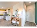 Bright entryway with wood-look floors, wood console table, and a view into the white kitchen at 505 Red Lovebird Ave # Lot 1229, Henderson, NV 89011
