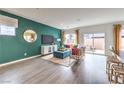 Open-concept living room featuring an accent wall, lots of natural light, and wood-look floors at 505 Red Lovebird Ave # Lot 1229, Henderson, NV 89011