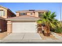 Two-story home featuring a desert landscape with a palm tree and a two-car garage at 5456 Raccoon Valley Ln, Las Vegas, NV 89122