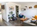 Inviting living room with stylish decor, wood-look flooring, comfortable seating, and an open doorway at 5733 Coral Sun St, North Las Vegas, NV 89031
