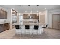 A spacious kitchen with granite countertops, pendant lighting, and a large center island with seating at 6790 Tangled Vines Ave, Las Vegas, NV 89139