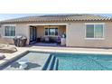 Inviting backyard with private pool, lounge chairs, and a covered patio dining area for outdoor enjoyment at 716 Cadence View Way, Henderson, NV 89011