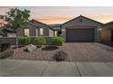 Charming single-story home featuring desert landscaping and a paved driveway leading to a two-car garage at 716 Cadence View Way, Henderson, NV 89011