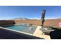 Backyard swimming pool with a serene waterfall feature and space for lounging at 716 Cadence View Way, Henderson, NV 89011