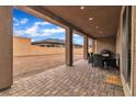 Covered patio featuring a tiled floor and an outdoor dining area overlooking the backyard at 741 Monroe Hill Pl, Henderson, NV 89011